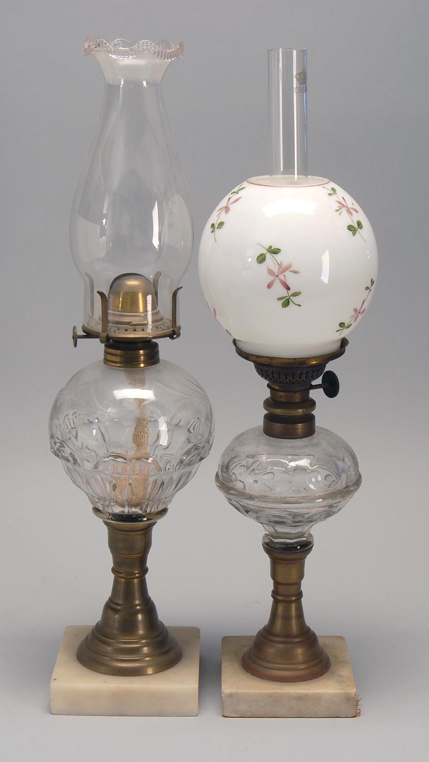 Appraisal: TWO MARBLE-BASED FLUID LAMPS with clear glass fonts One in