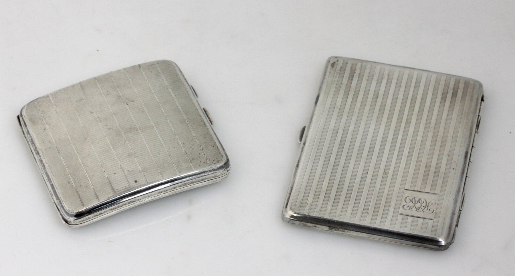 Appraisal: A silver cigarette case Birmingham of curved form and another