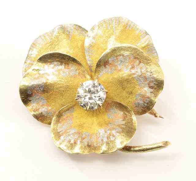 Appraisal: DIAMOND AND FOURTEEN KARAT GOLD PENDANT BROOCH the gold flower