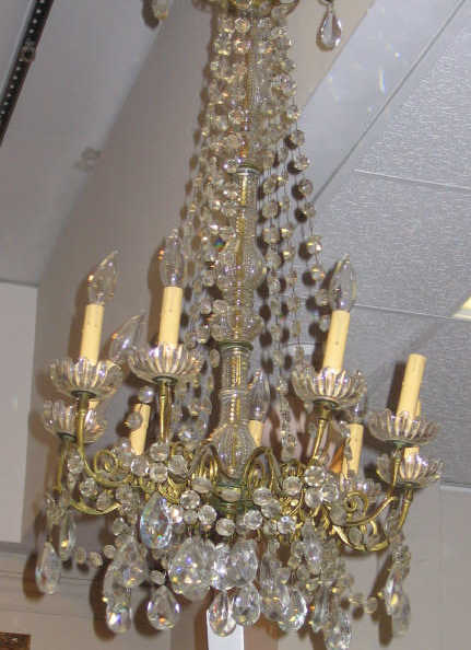 Appraisal: CONTINENTAL GILT BRONZE AND CRYSTAL CHANDELIER Nine lights on Rococo