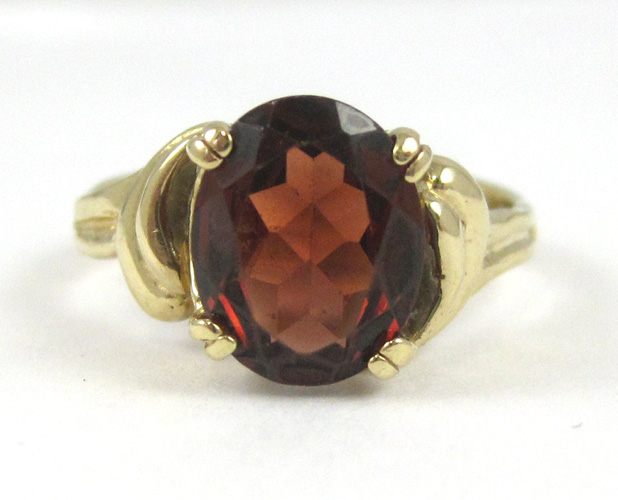 Appraisal: GARNET AND FOURTEEN KARAT GOLD RING with four yellow gold