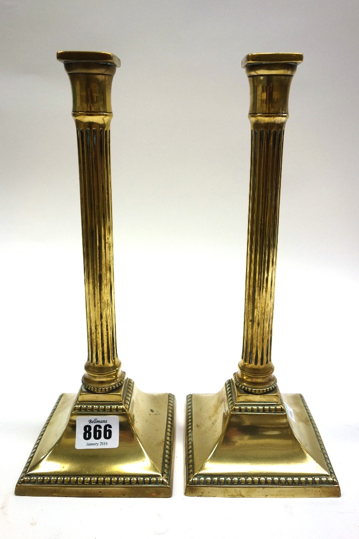 Appraisal: A pair of brass candlesticks by Edward Kendrick early th