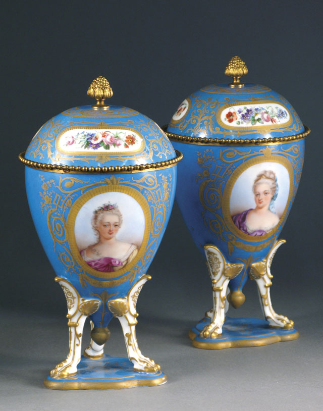 Appraisal: PAIR OF SEVRES COVERED URNS ovoid form raised on three