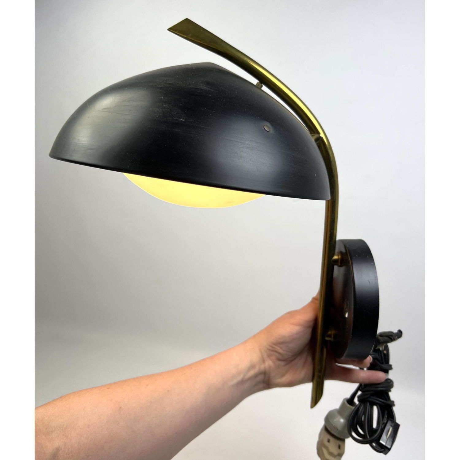 Appraisal: Brass Arm Black Dome Shade Modernist Wall Sconce Light GLOBE