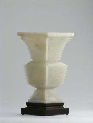 Appraisal: A Chinese pale celadon jade gu-shaped vase carved with taotie