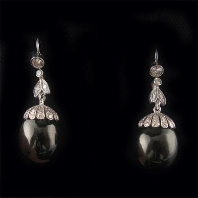 Appraisal: A pair of diamond and onyx drop earrings the onyx