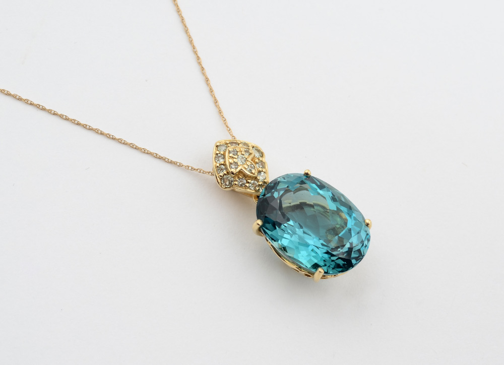 Appraisal: BLUE TOPAZ PENDANT NECKLACE K yellow gold pendant contains a