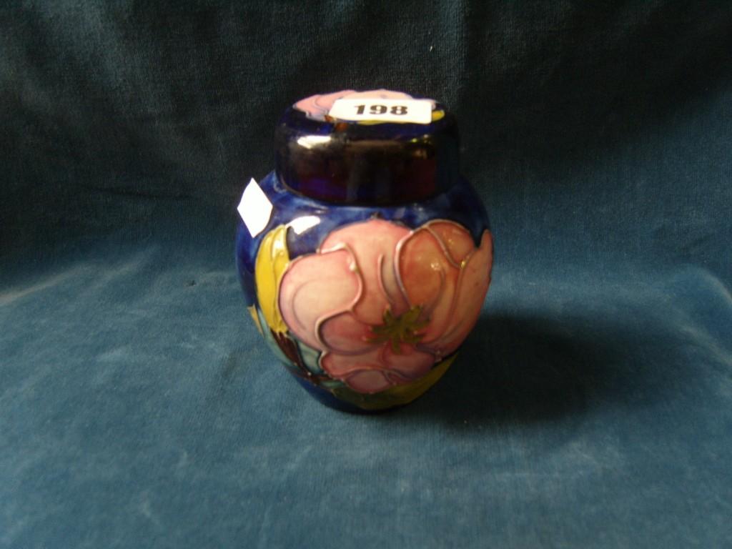 Appraisal: A blue ground Moorcroft ginger jar and cover with magnolia