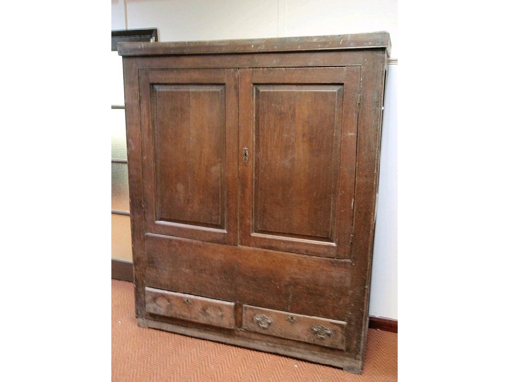 Appraisal: A Georgian oak cupboard converted to a wardrobe in the