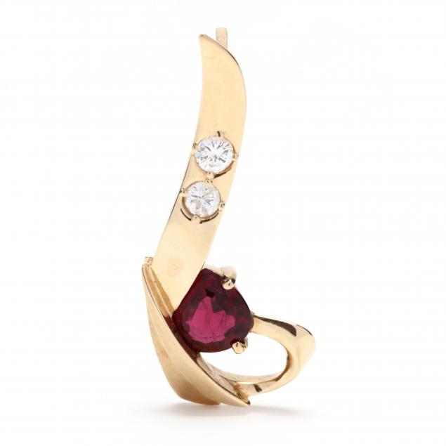 Appraisal: GOLD GARNET AND DIAMOND SLIDE Designed in a ribbon motif