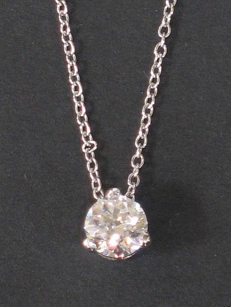 Appraisal: A SOLITAIRE DIAMOND PENDANT with a round brilliant-cut diamond in