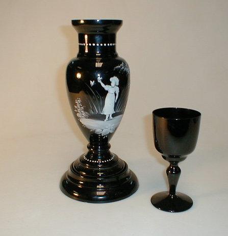 Appraisal: A black glass vase with Mary Gregory style decoration on