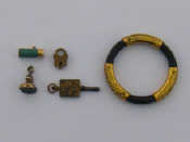 Appraisal: A mixed lot comprising three vintage charms a watch key