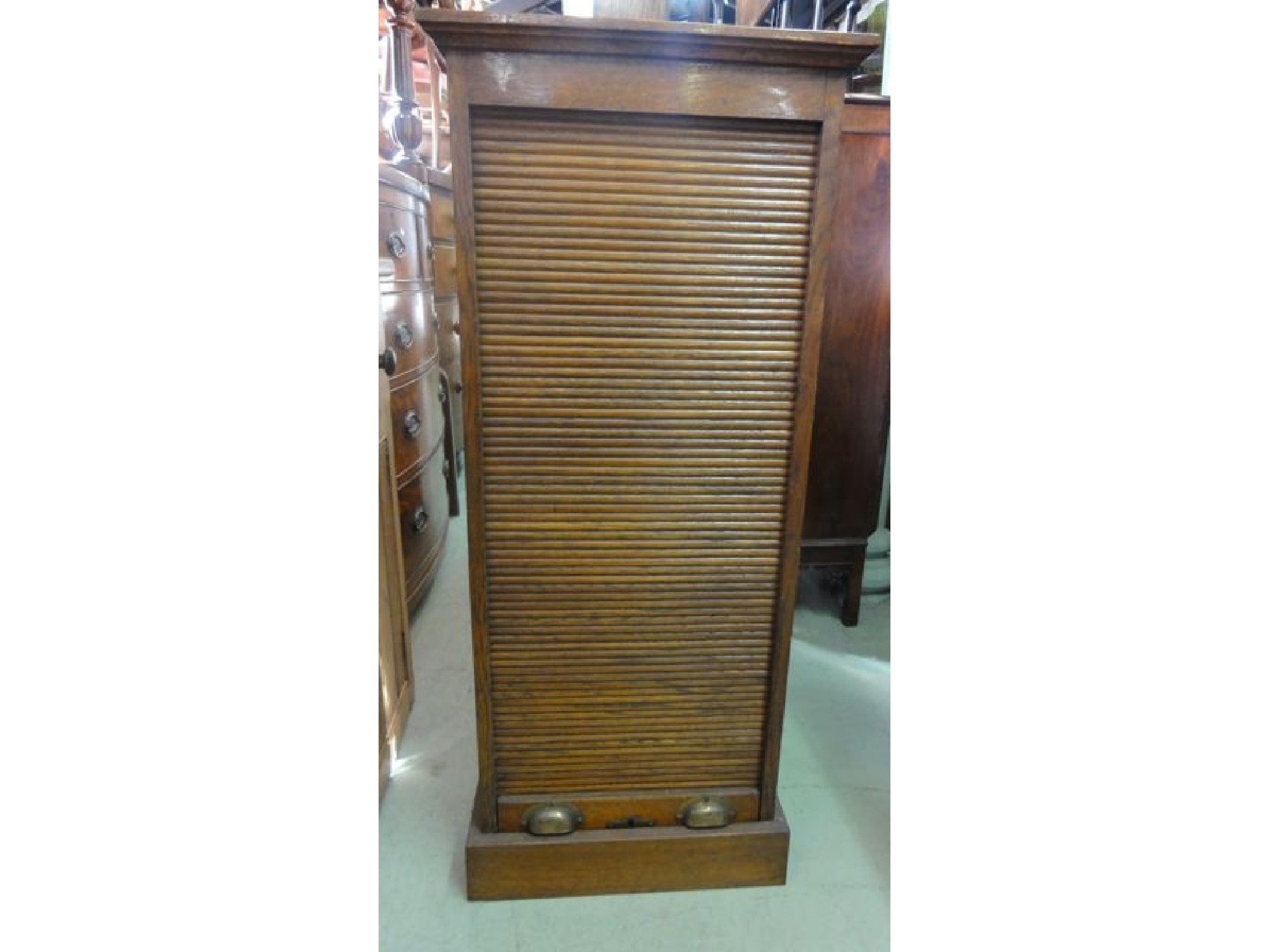 Appraisal: An Edwardian oak pedestal filing cabinet enclosed by a rise