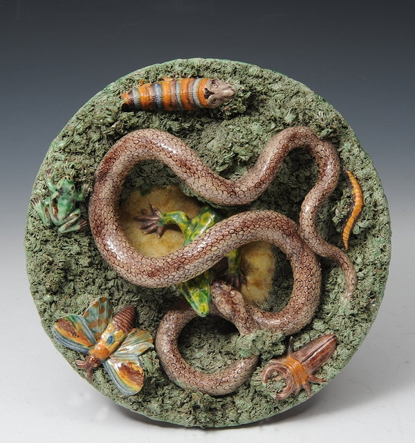 Appraisal: A PORTUGUESE PALISSY STYLE CHARGER the thick moss green ground