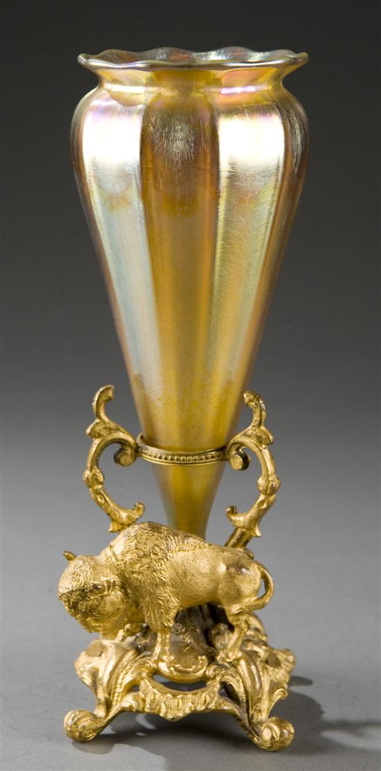 Appraisal: Iridescent glass vase in a gilt bronze stand with buffalo