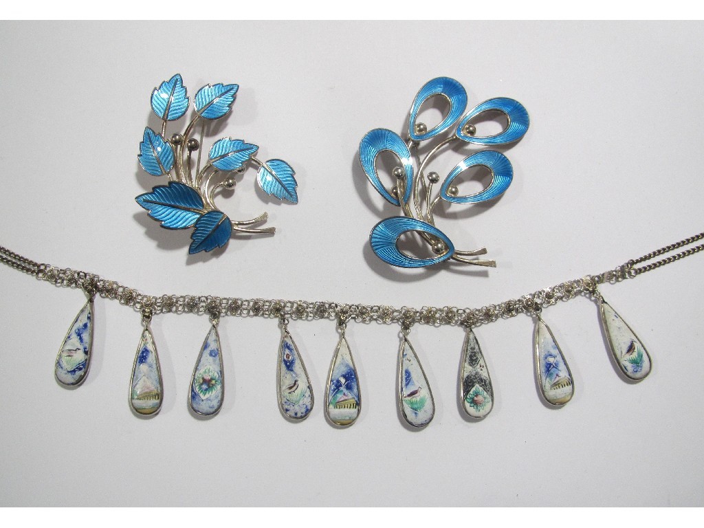 Appraisal: Lot comprising two silver and blue enamel foliate brooches and