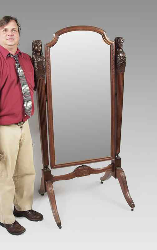 Appraisal: CARVED MAHOGANY CHEVAL MIRROR Three dimensional maiden head figural supports