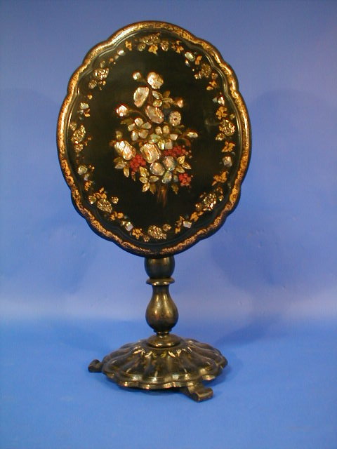 Appraisal: A William IV black papier-mach tea table with oval scalloped