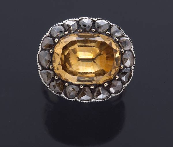 Appraisal: A yellow topaz and diamond ring mounted in silver-topped gold