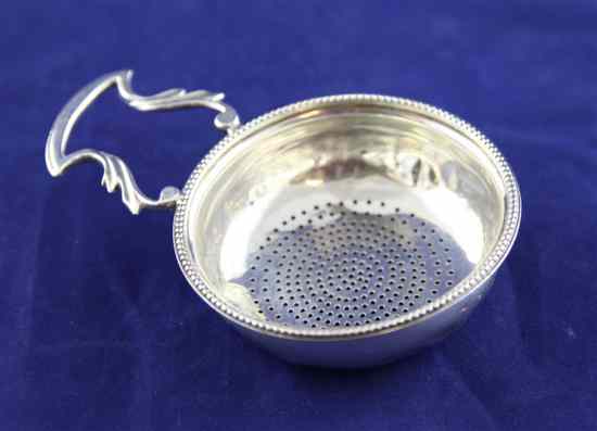 Appraisal: A George III silver lemon strainer with angular foliate handles