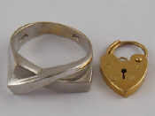 Appraisal: A white metal tests ct gold cross over ring approx