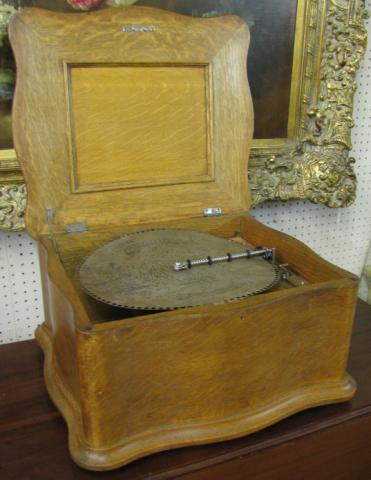 Appraisal: Regina table top music box in oak serpentine case with