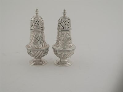 Appraisal: A pair of embossed late Victorian peppers of vase form