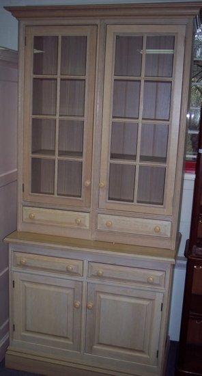 Appraisal: An oak cupboard with moulded cornice above shelves enclosed by