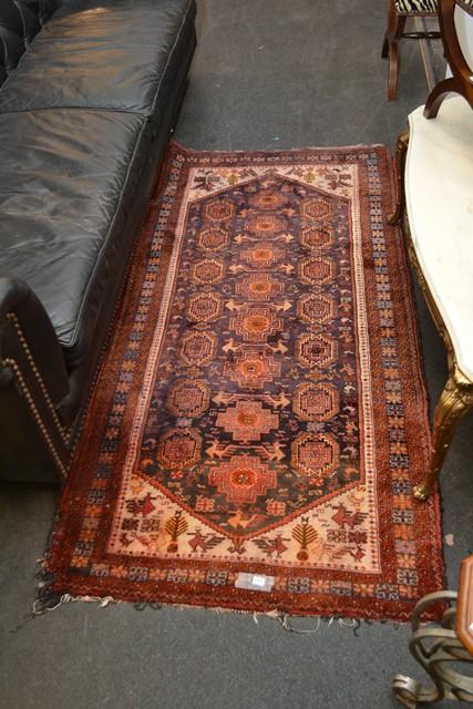 Appraisal: A PERSIAN RUG IN RED BLUE TONES