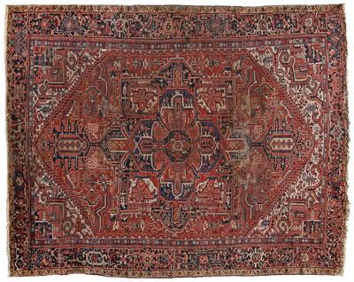 Appraisal: Heriz rug geometric and floral designs on red field ft