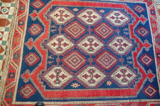 Appraisal: A PERSIAN FLOOR RUNNER The geometric field in colours of