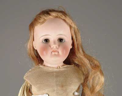 Appraisal: CLOSE MOUTH SHOULDER HEAD DOLL Stoic looking shoulder head marked