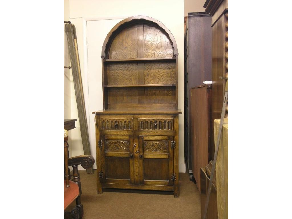 Appraisal: A reproduction solid dark oak dresser twin-shelf canopy back above