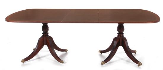 Appraisal: Sheraton style inlaid mahogany dining table crossbanded top turned pedestals