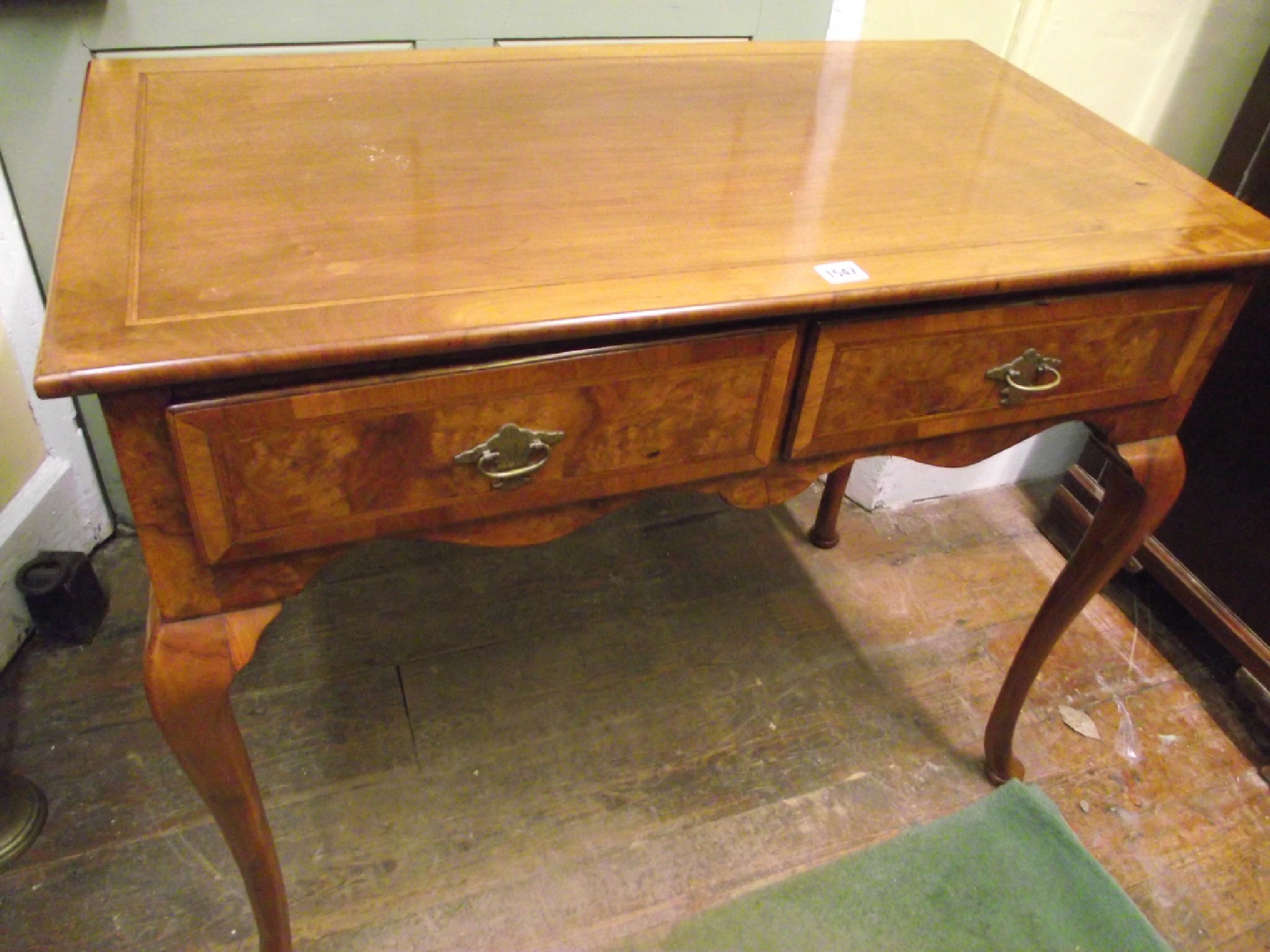 Appraisal: A Georgian style side table in walnut enclosing two frieze