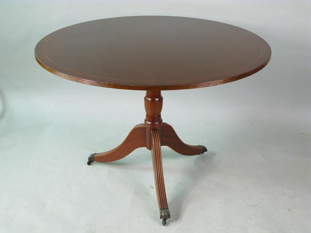 Appraisal: A reproduction mahogany tilt-top dining table cross-banded top on tripod