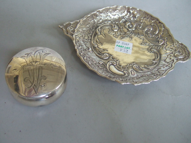 Appraisal: A silver circular hinge lidded pill box the lid monogram