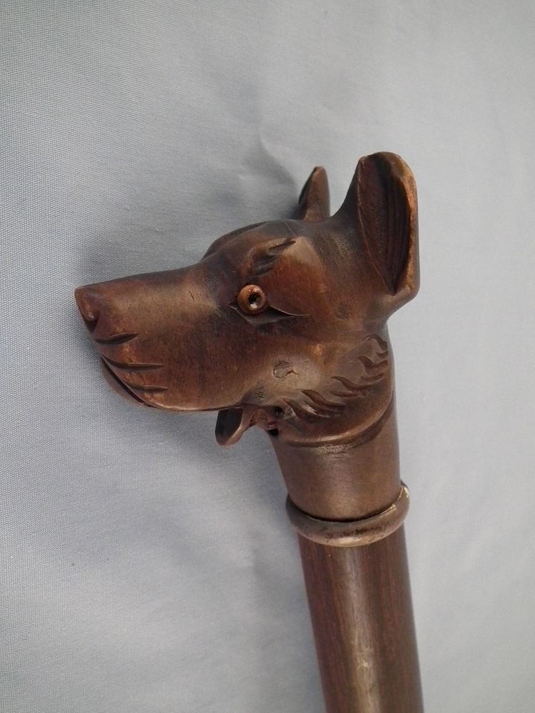 Appraisal: JOINTED DOG HEAD CANE Antique carved wood dog head cane