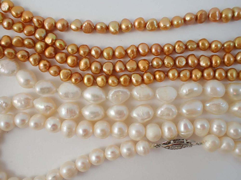 Appraisal: THREE FRESHWATER PEARL NECKLACES unattached strand of yellowish orange brown