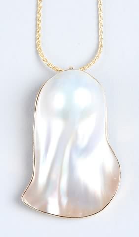 Appraisal: KY gold bezel holding a large blister pearl with lustre