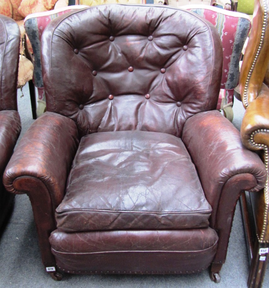 Appraisal: A pair of early th century burgundy leather armchairs with