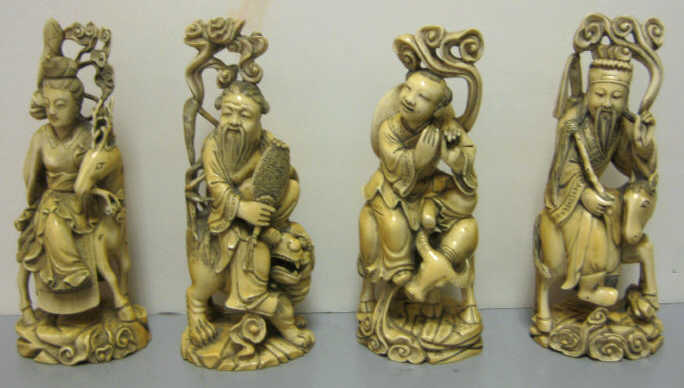 Appraisal: FOUR CHINESE CARVED IVORY FIGURE GROUPS Each figure seated on