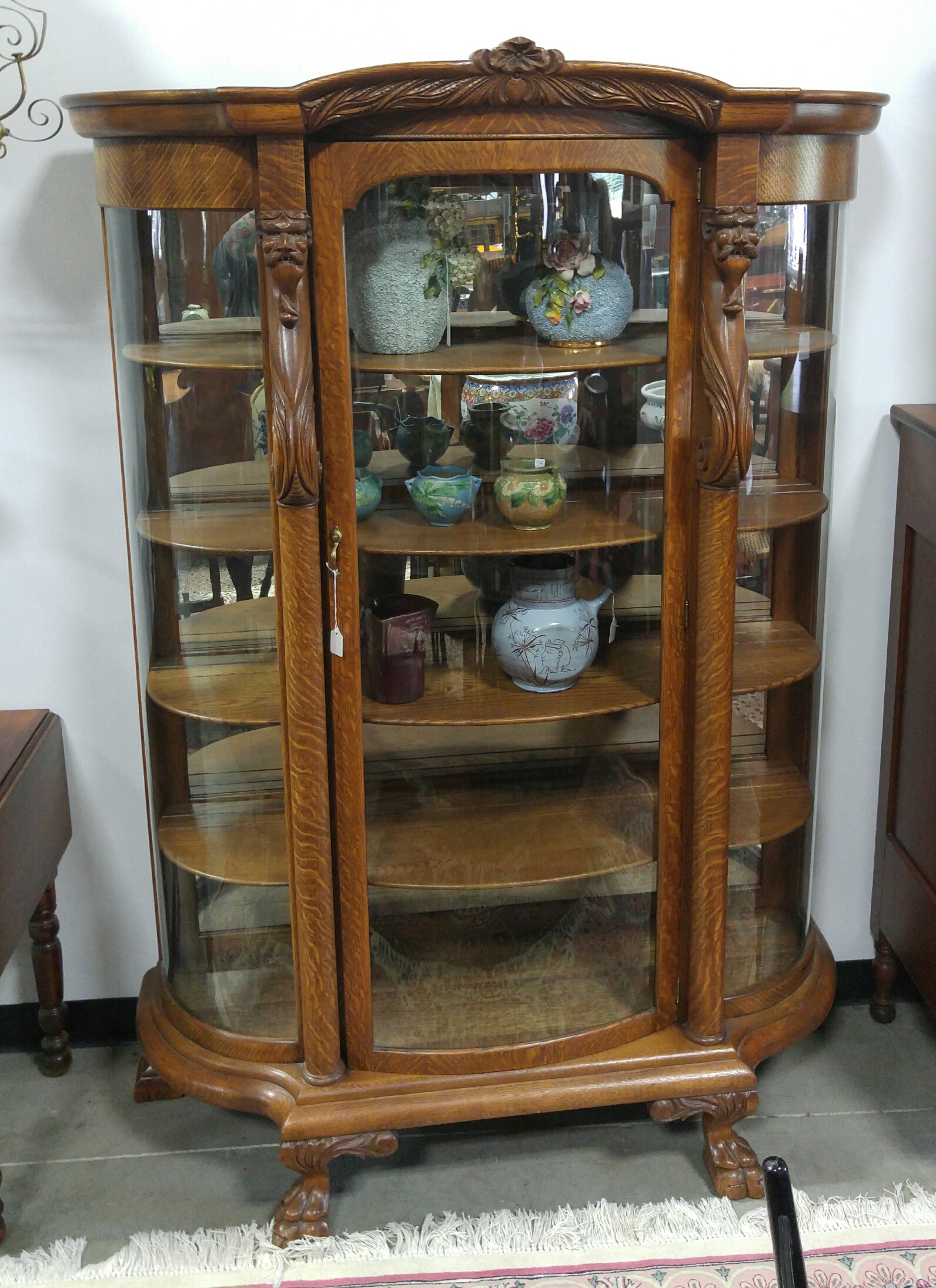 Appraisal: CURVED GLASS CHINA CABINET American st quarter- th century oak