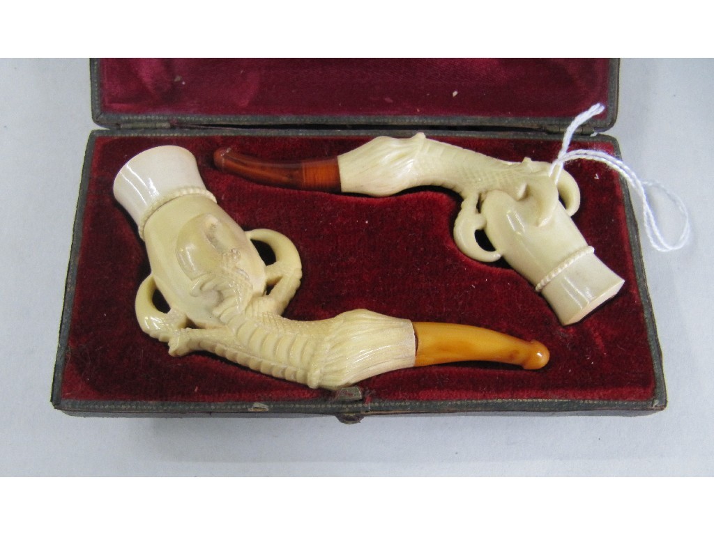 Appraisal: Cased pair of carved ivory pipes