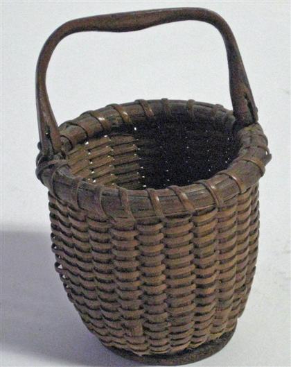 Appraisal: One egg-size Nantucket basket Shaped handle turned bottom H in