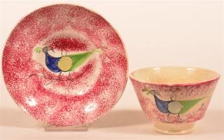 Appraisal: Red Spatter Peafowl Pattern Cup and Sauce Red gray and