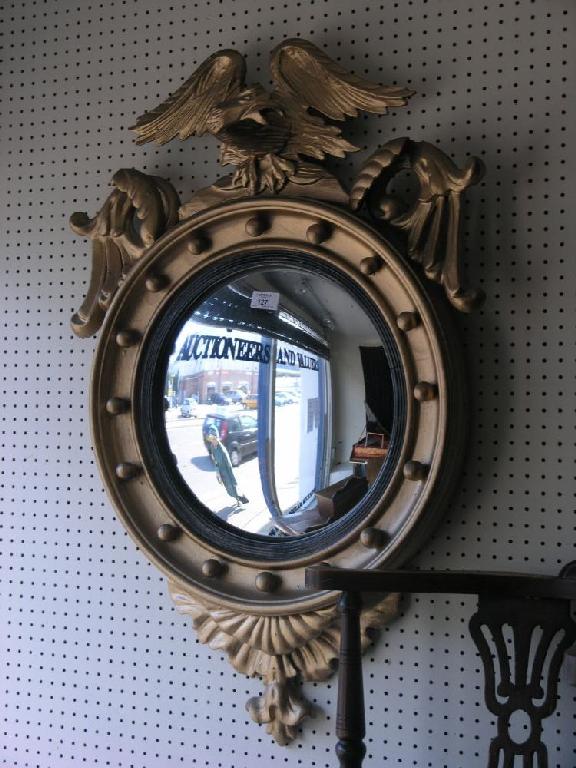 Appraisal: A Regency style gilt convex wall mirror with carved eagle