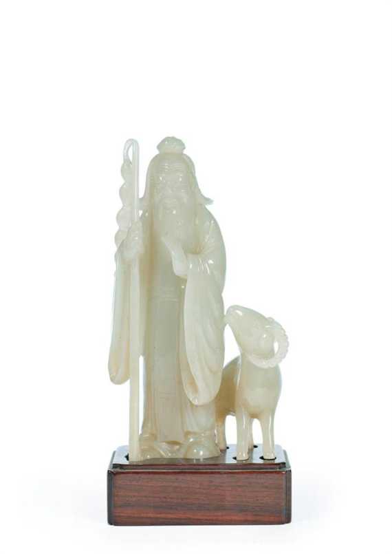 Appraisal: A FINE GREENISH JADE CARVING OF A SAGE WITH HIS