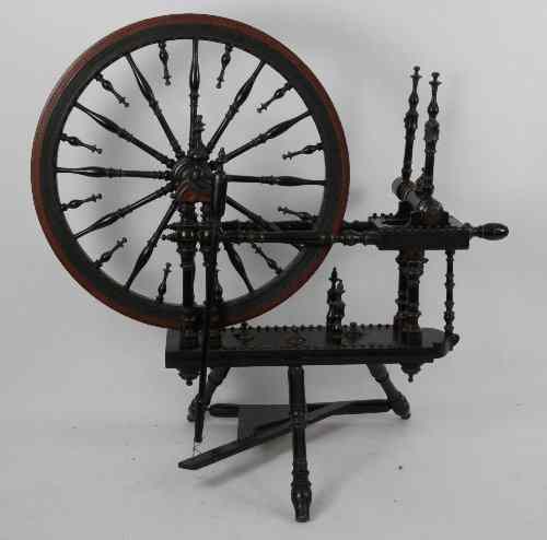 Appraisal: A th Century turned cherry wood spinning wheel with bobbins